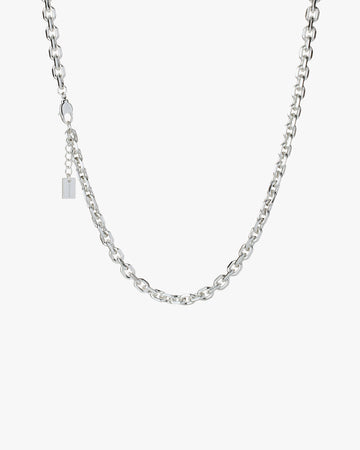 Silver chain necklace on a light grey background