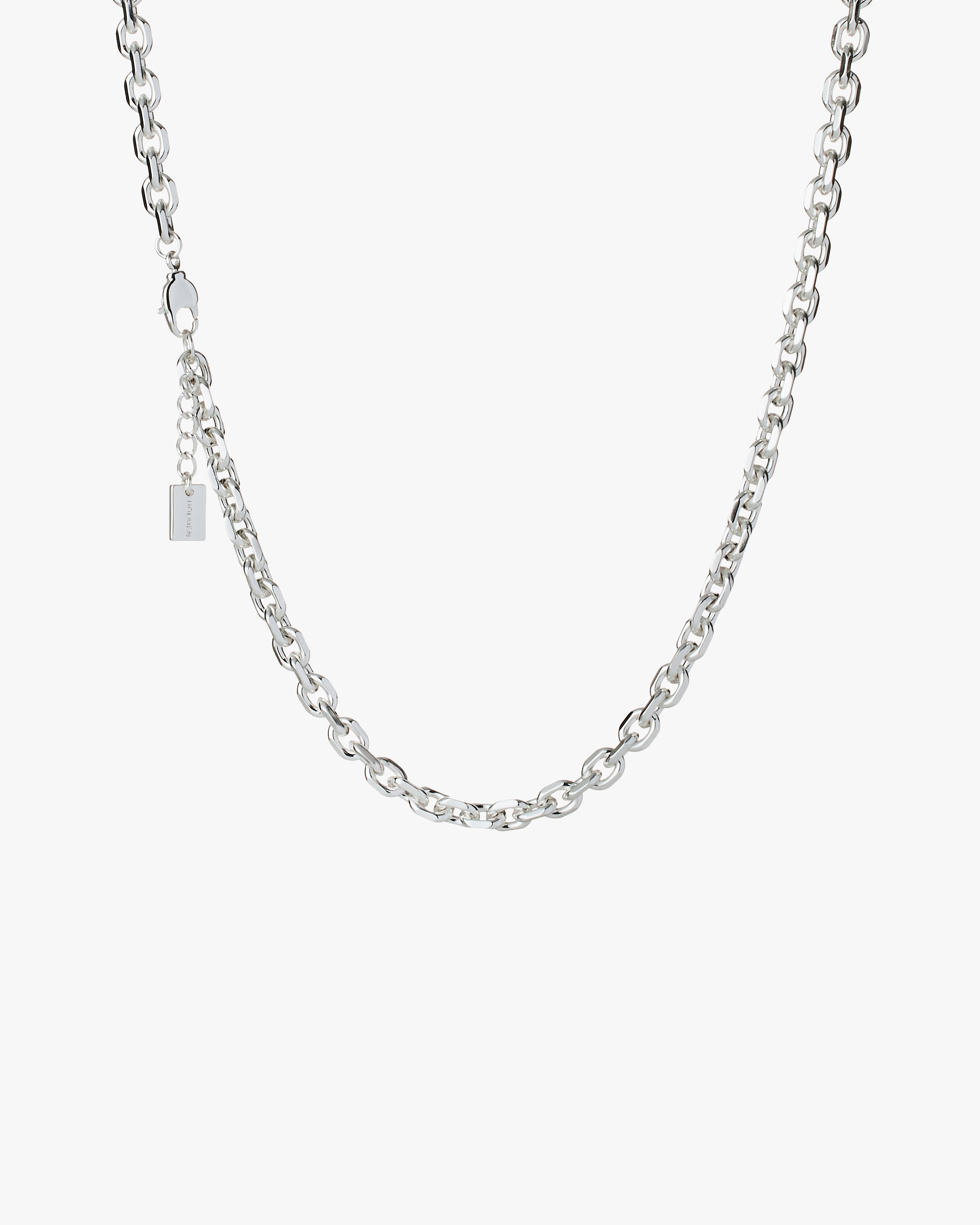 Silver chain necklace on a light grey background