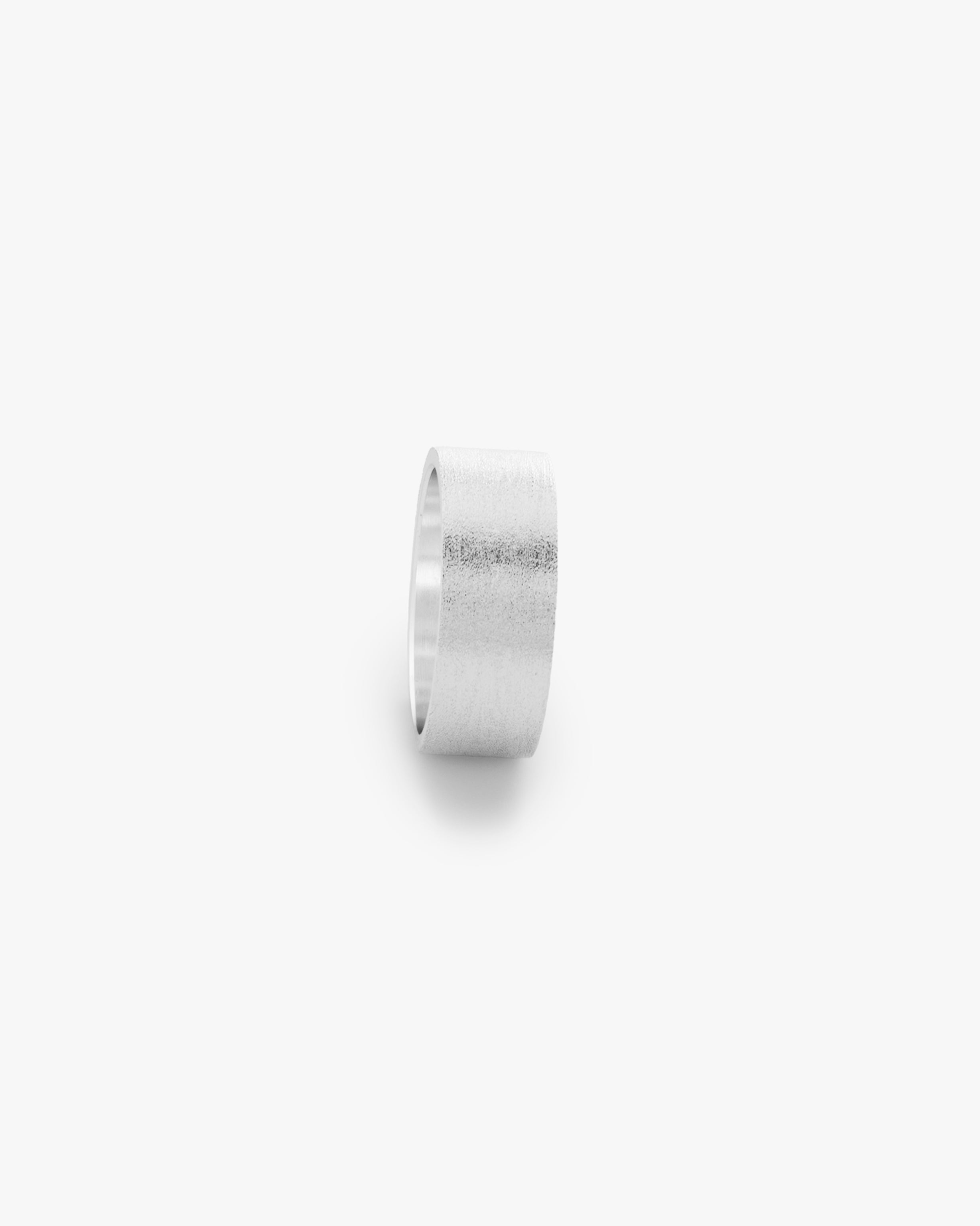 Silver ring on a light grey background