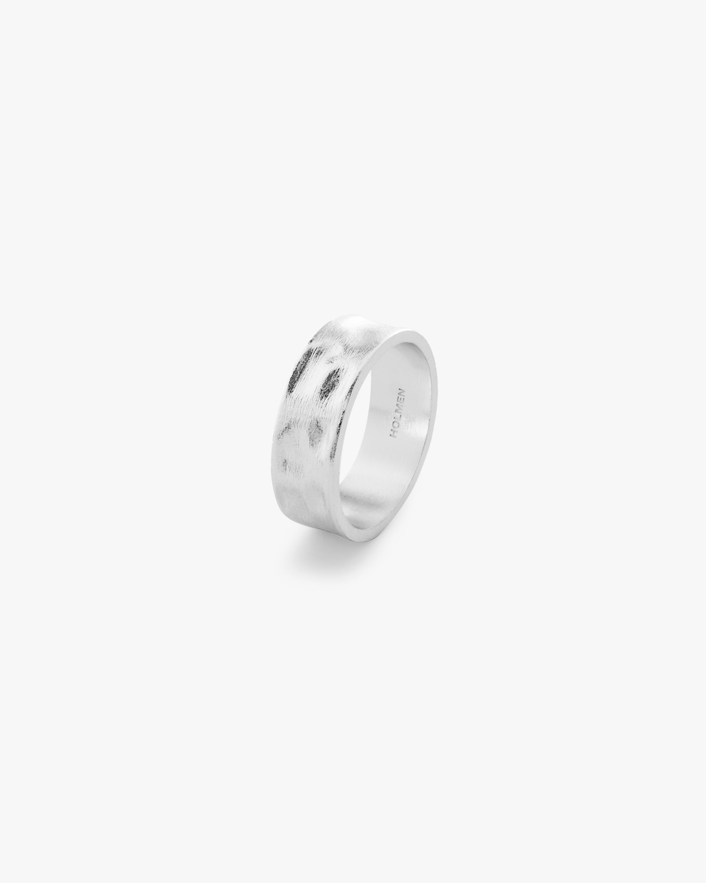 Silver ring with 'HOLMEN' engraving on a light grey background