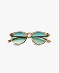 Gold-framed sunglasses with green lenses on a light grey background