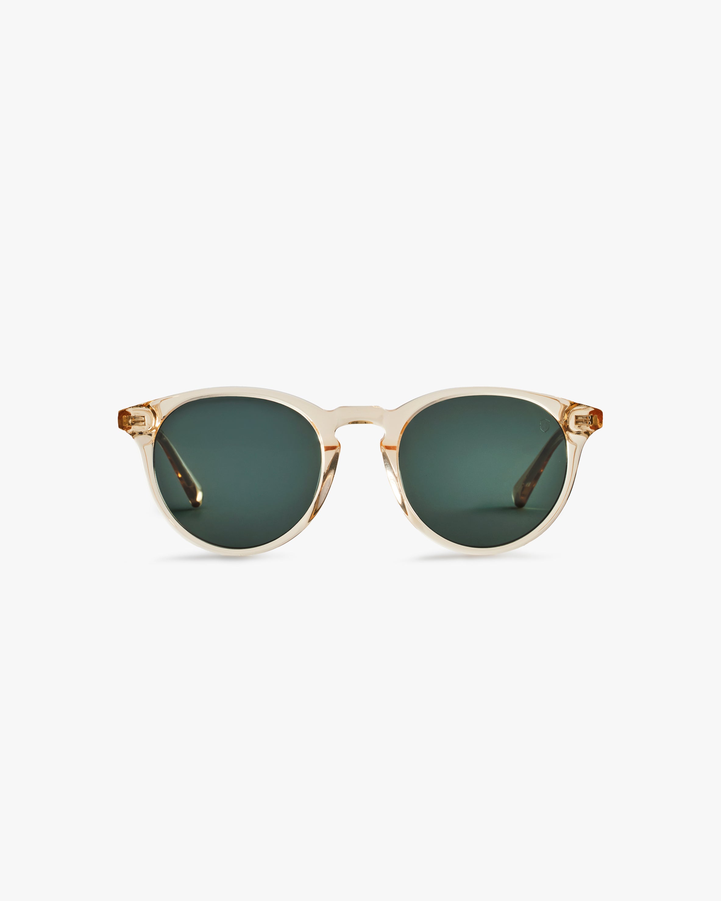 Gold-framed sunglasses with green lenses on a light grey background