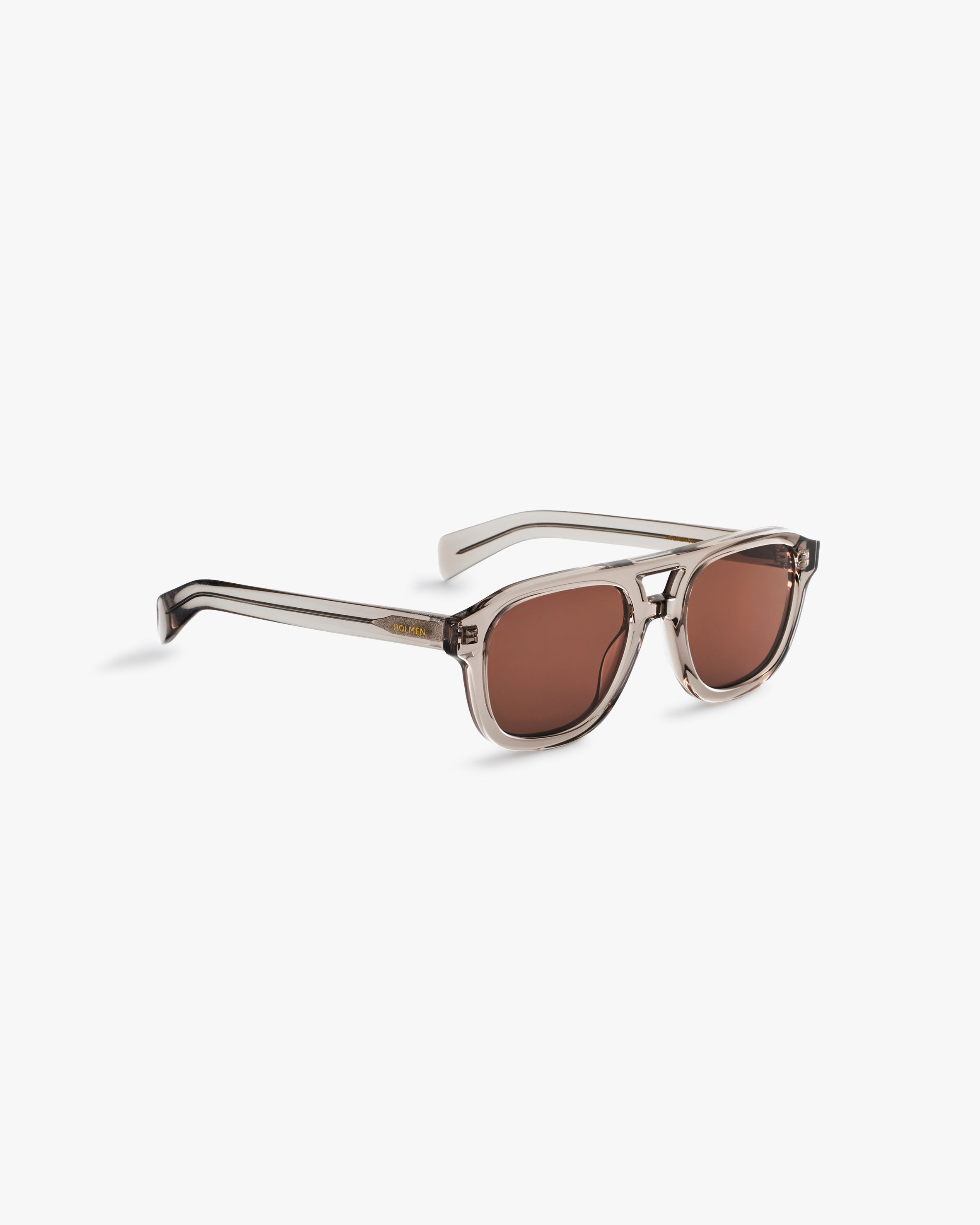 Sunglasses with brown lenses on a light grey background