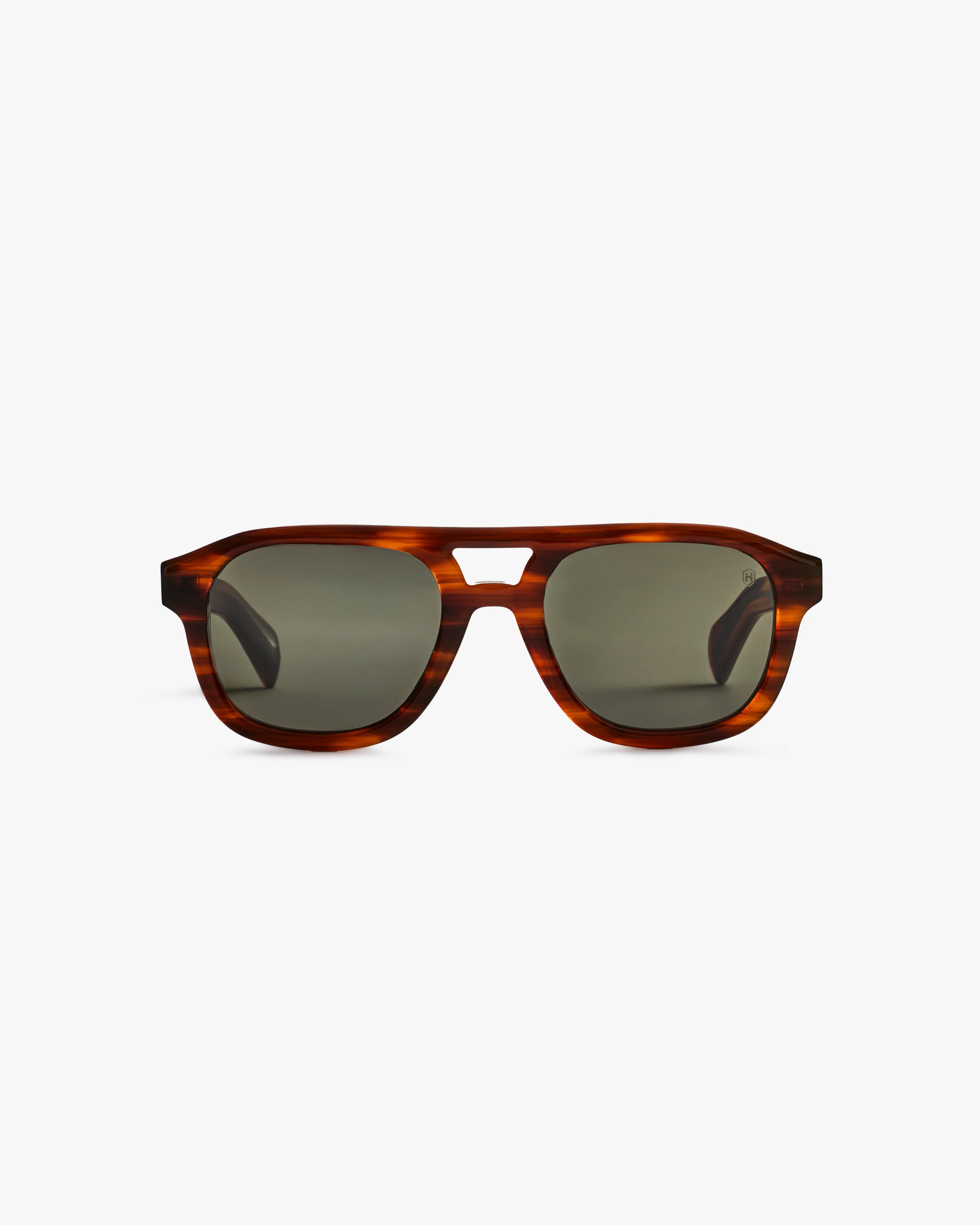 Sunglasses with tortoiseshell frame and dark lenses on a light grey background
