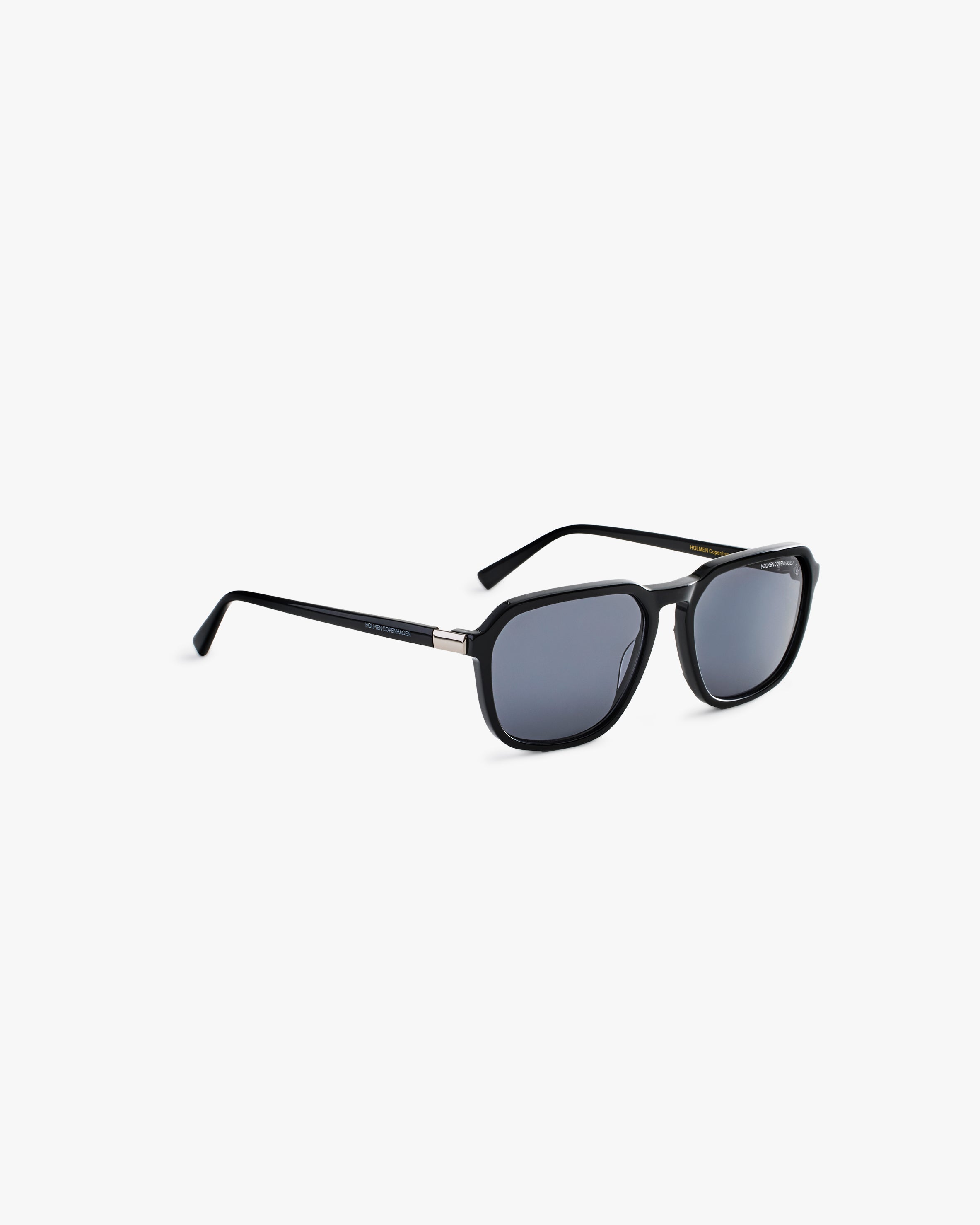 Black sunglasses on a light grey background