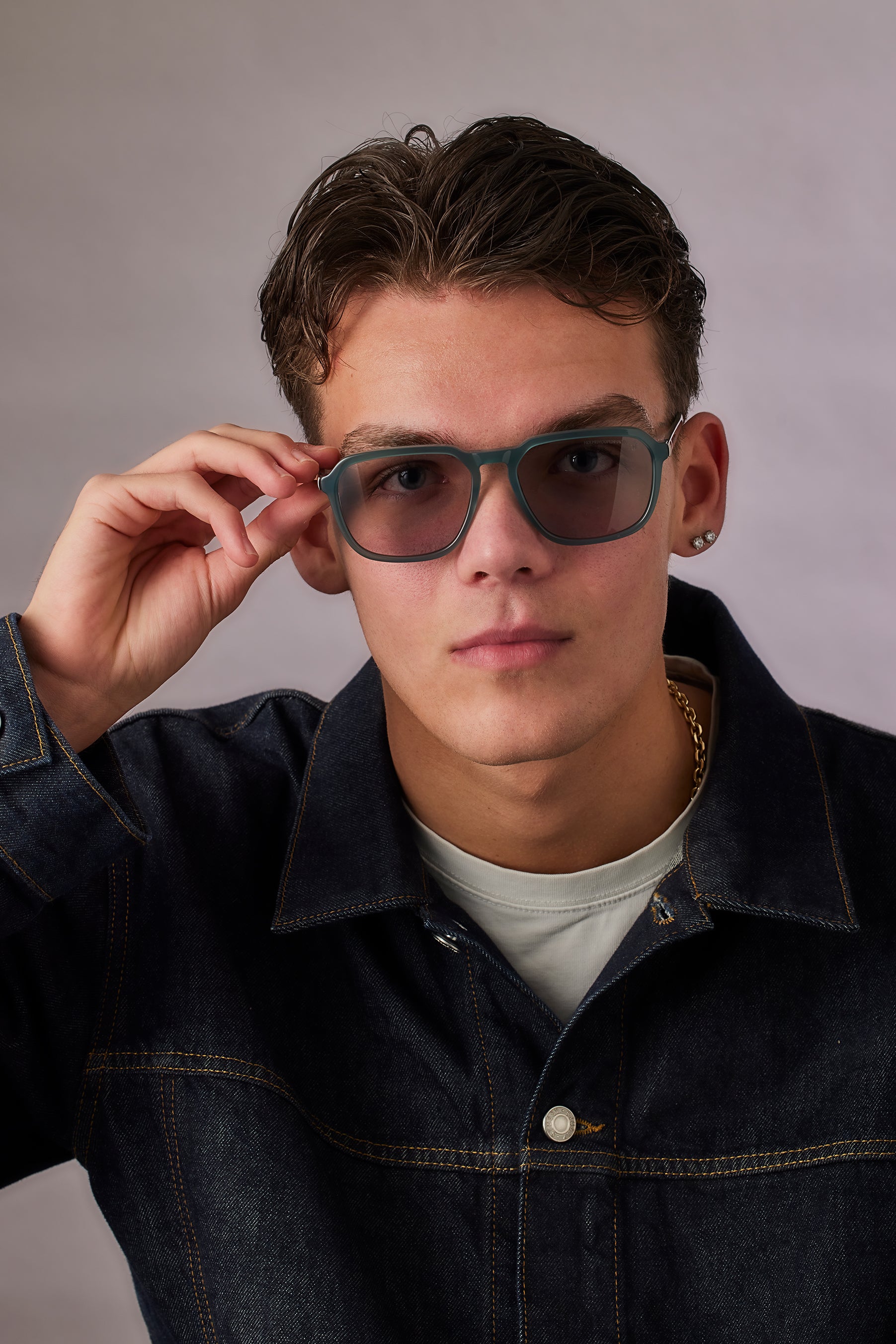 Person wearing sunglasses with a neutral background
