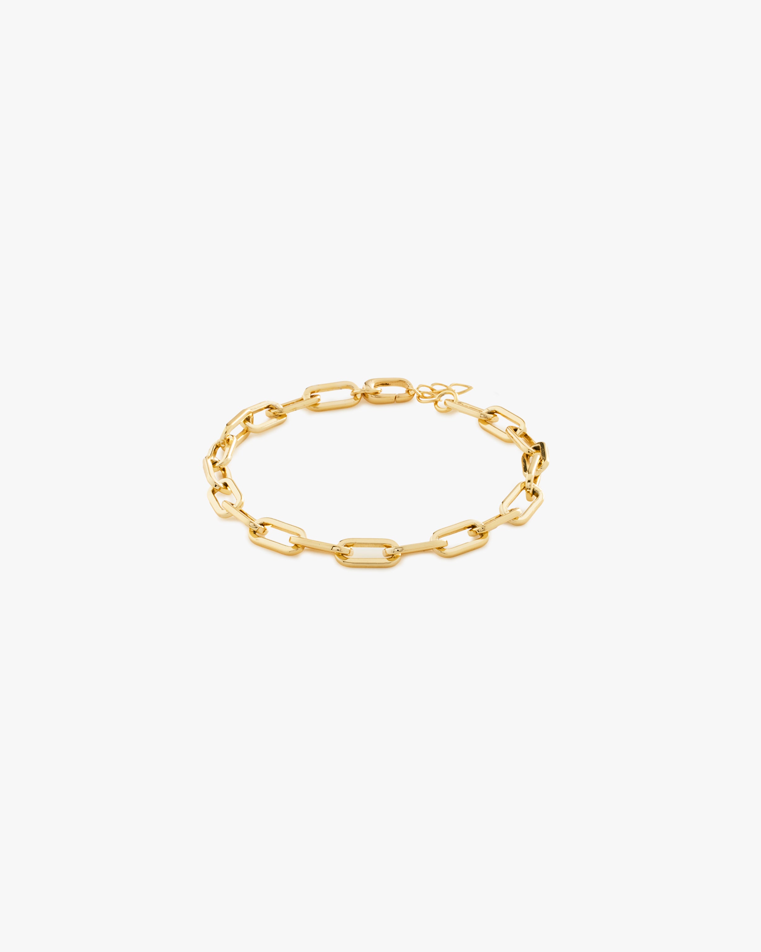 Gold chain bracelet on a light grey background