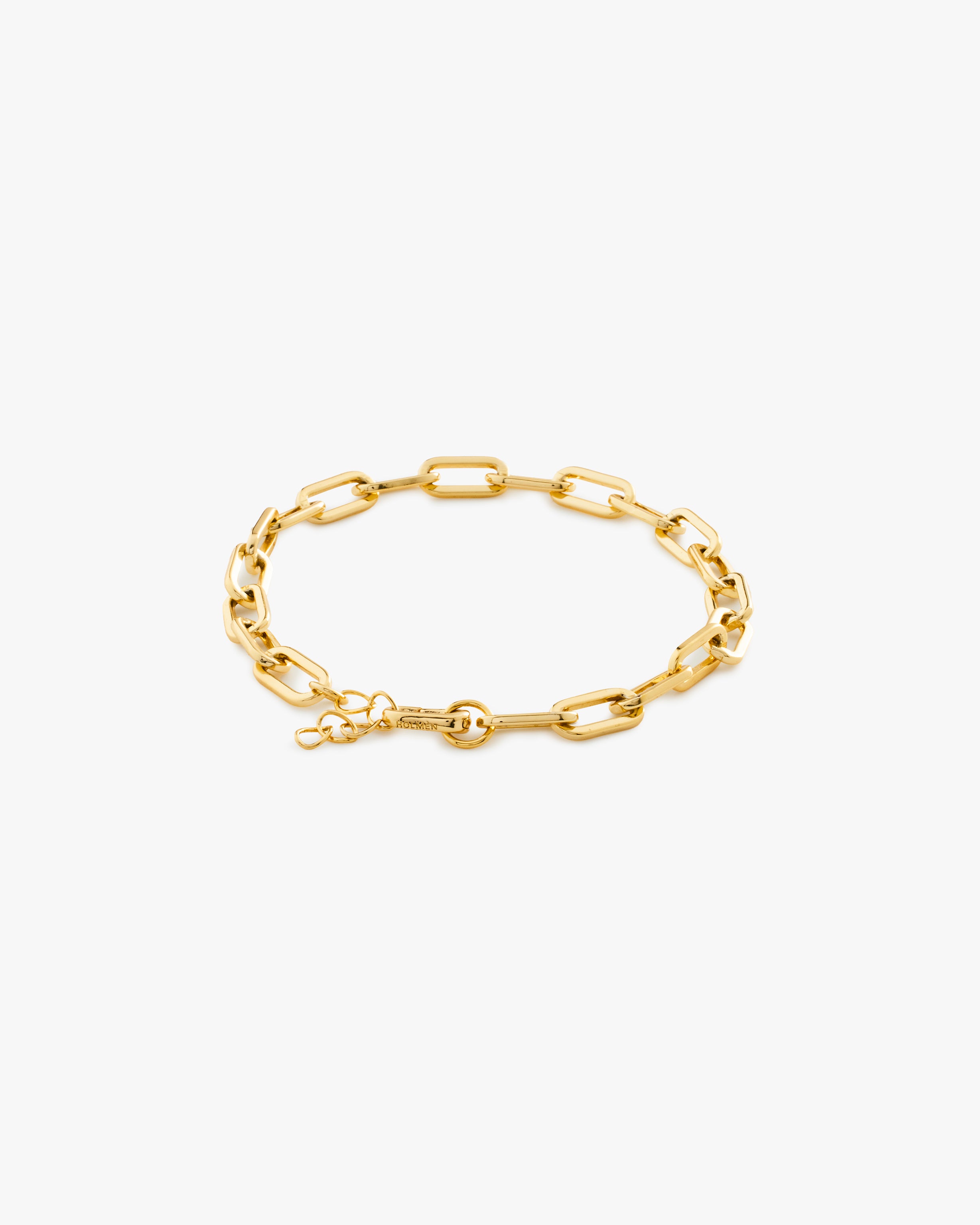 Gold chain bracelet on a light grey background