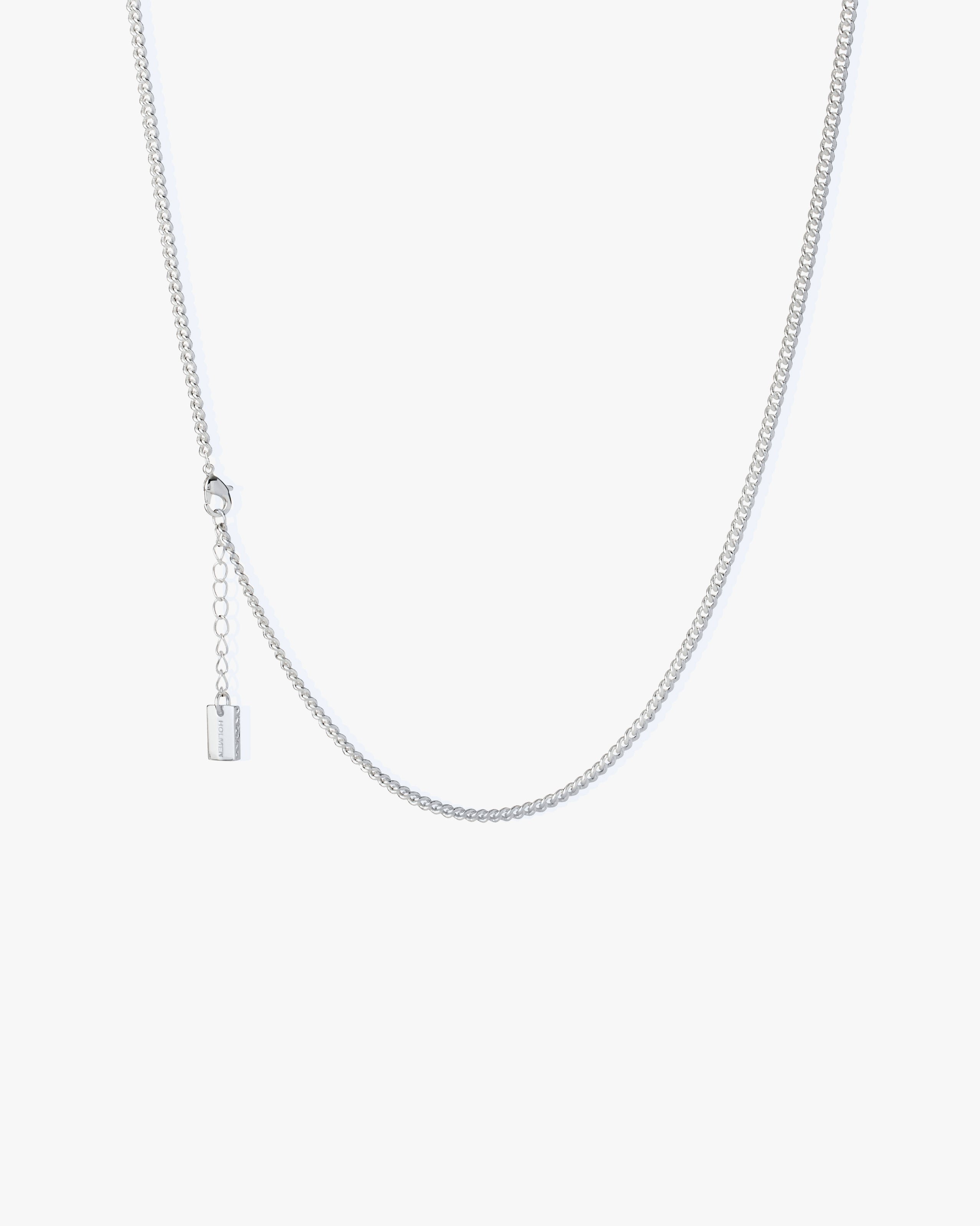 Silver necklace on a light grey background