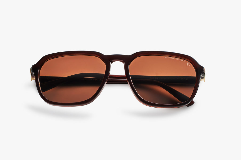 Brown sunglasses with a reflective surface on a white background